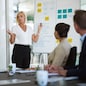 Presentation, woman and whiteboard with staff in office for workflow steps, diagram and teamwork for web design. Female speaker, people and meeting of strategy process, chart and interface project.
