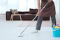Maid using mop with bucket plastic of cleaner equipment to mopping cleanup floor in living room.