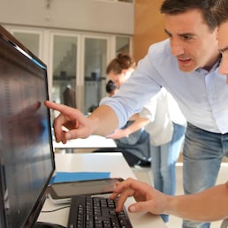 Teacher and student working on computer