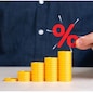 Growing stack of coins and percentage symbol. Capital growth and increase of savings on deposit and investments. Financial planning, return on investment, and interest compounding.
