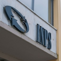 Carrara, Italy - May 24, 2020 - The INPS sign, the national social security institute that deals with providing pensions and collecting labor contributions, on the office building
