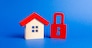 A wooden house and a red padlock. Unavailable and expensive real estate. house Insurance. Security and safety. Confiscation for debts. alarm system. seizure of property. Protection of property rights.