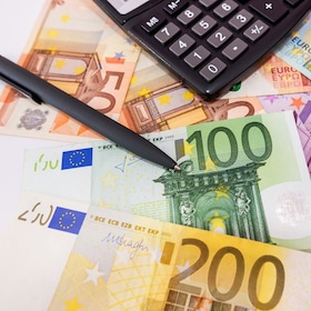 different euro banknotes, calculator, magnifier and pen. Financial concept.