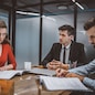 Studying documents. A couple reading legal papers in a lawyers office