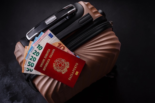 International passport of a citizen of Italy on a suitcase, departure from the airport, international travel