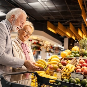 A happy senior shoppers are purchasing at hypermarket.