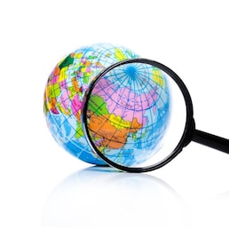 Globe under magnifying glass zooming Russia and China on white background