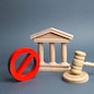 Courthouse with judge's gavel and sign NO. concept of censorship and the production of restrictions and laws on restriction. Anti-popular laws, usurpation of power, conservative views. Lack of justice