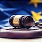 Judges wooden gavel with EU flag in the background. Symbol for jurisdiction.