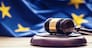 Judges wooden gavel with EU flag in the background. Symbol for jurisdiction.