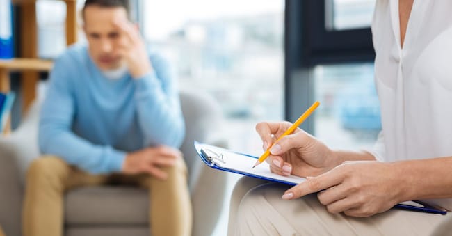 Preliminary diagnosis. Selective focus of psychologist notes being written during a psychological session