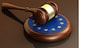 European Union laws, legal system and parliament concept with a 3d render of a gavel on a wooden desktop and the EU flag.