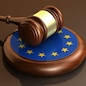 European Union laws, legal system and parliament concept with a 3d render of a gavel on a wooden desktop and the EU flag.