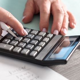 Female accountant using calculator in office