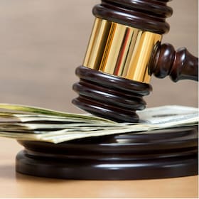 Law gavel on a stack of American money