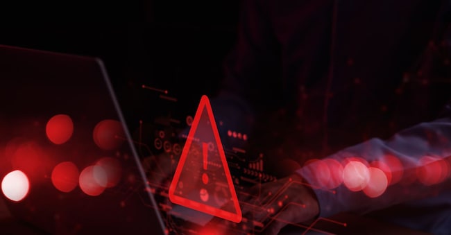System hacked warning alert on notebook (Laptop). Cyber attack on computer network, Virus, Spyware, Malware or Malicious software. Cyber security and cybercrime. Compromised information internet.
