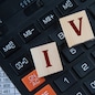 IVA (Individual Voluntary Arrangement) - acronym on wooden cubes on the background of a calculator. Business concept