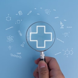 Healthcare access and wellness Medical care concept with a magnifying glass, family, and plus sign icons.