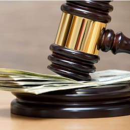 Law gavel on a stack of American money