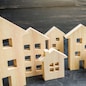 City of wooden figurines of houses. Buying and selling real estate. Renovation and home improvement. Mortgage loan. Building maintenance. Renting housing, realtor services.