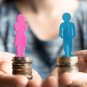 Conceptual image of gender pay gap using piled coins and male female figurines. Equal pay issues. AI