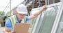 Construction Worker Preparing To Fit New Windows