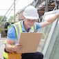Construction Worker Preparing To Fit New Windows