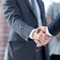 closeup of handshake of business partners on the background of business team