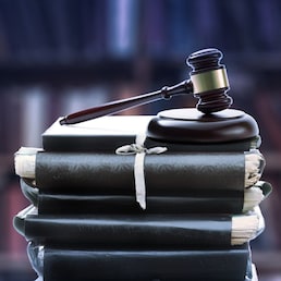 Stack of old paper folders and gavel