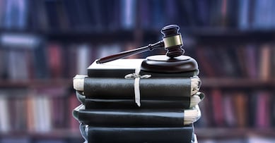 Stack of old paper folders and gavel