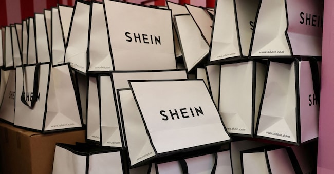 FILE PHOTO: A company logo for fashion brand Shein is seen on a pile of gift bags on its Christmas bus as part of a nationwide promotional tour in Liverpool, Britain, December 14, 2024. REUTERS/Phil Noble/File Photo