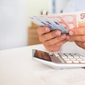 Male hand computer calculator money pen