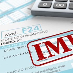 close up view of F24 form for italian taxes,the word imu and an electronic calculator (3d render)