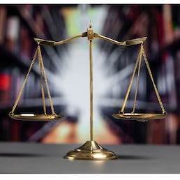 Shiny golden balanced scale in court library background as concept justice and fairness legal symbol. Scale balance for righteous and equality judgment by lawyer and attorney. equility
