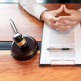 lawyer or judge business man working with paperwork agreement contract and gavel in Courtroom, Justice and Law firm Notary public concept.