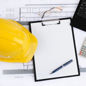 Black clipboard with copy space and construction helmet on the table builder