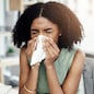 Blowing nose, tissue or sick black woman in office with virus or worker with allergies, problems or illness. Person sneezing or African girl employee with toilet paper, allergy flu or fever disease.