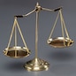 Shiny golden balanced scale in courtroom background as concept justice and a common legal symbol. Scale balance for righteous and equality judgment by lawyer and attorney. Equilibrium