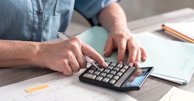 Female accountant using calculator in office