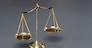 Shiny golden balanced scale in courtroom background as concept justice and a common legal symbol. Scale balance for righteous and equality judgment by lawyer and attorney. Equilibrium