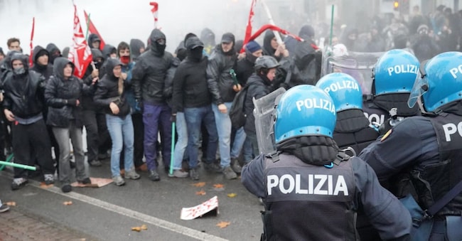 Scontri a Torino tra antagonisti e forze dell'ordine durate il corteo dopo lo sgombero di Askatasuna. Un gruppo di persone incappucciate in testa alla manifestazione ha cercato di sfondare il cordone della polizia lanciando bottiglie e oggetti. Le forze dell'ordine hanno risposto con idranti e lacrimogeni. Ci sono state cariche con manganellate da un lato e bastonate da parte dei manifestanti. Torino, 20 dicembre 2025. ANSA / TINO ROMANO