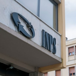 Carrara, Italy - May 24, 2020 - The INPS sign, the national social security institute that deals with providing pensions and collecting labor contributions, on the office building