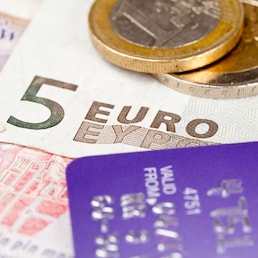 Macro of debit card and on top of euro note to illustrate currency crisis in Europe