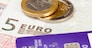 Macro of debit card and on top of euro note to illustrate currency crisis in Europe