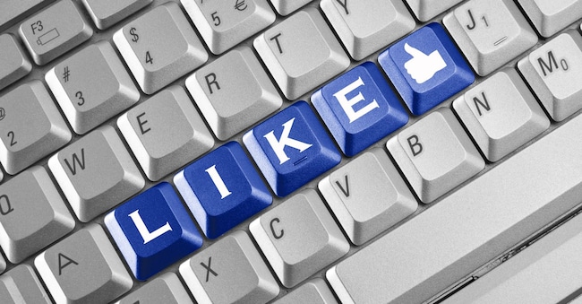 Social network concept . Keyboard with blue Like button.