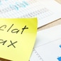 Memo with flat tax on an office table.