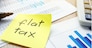 Memo with flat tax on an office table.