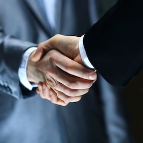 Handshake - Hand holding on black background