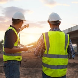 The chief civil engineer is introducing inspection of a road or expressway construction project under the road to an intern. At the expressway construction site