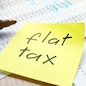 Memo with flat tax on an office table.